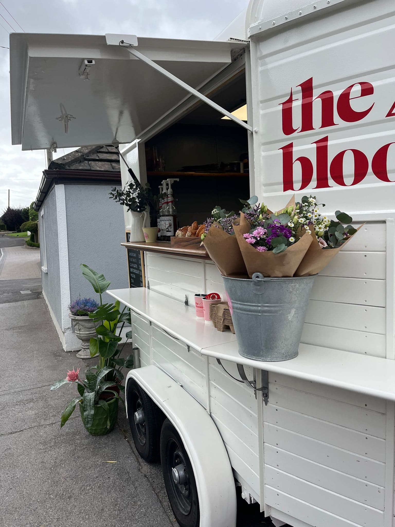 Coffee trailer lit up at dusk